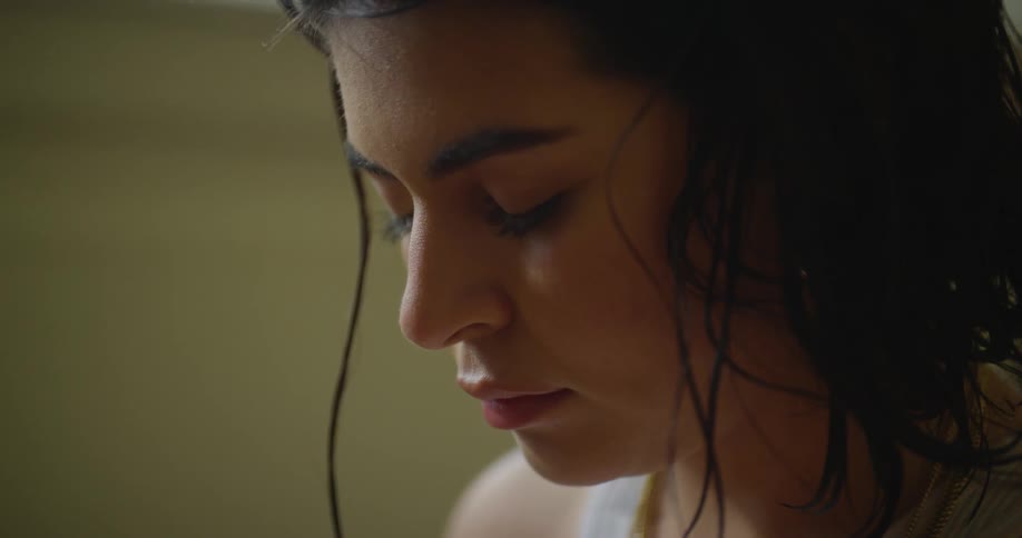 A portrait of a sad looking woman with dark brown hair