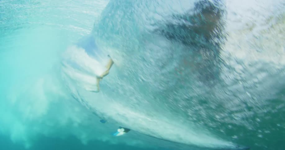 A surfer hand drag inside barreling wave