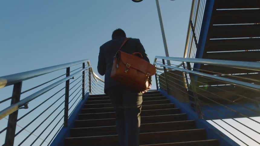 A man walks up the staircase