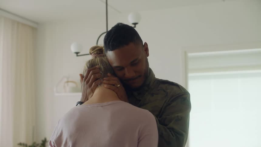 A woman leans into a man after he kisses her then he caresses the nape of her neck