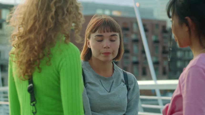 Three girls talking and leaving