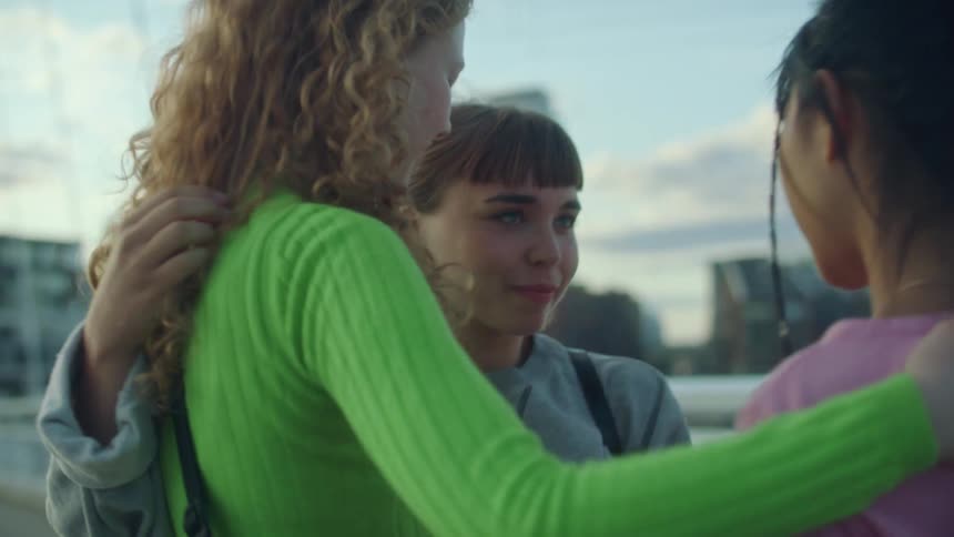 A group of three friends hugging each other