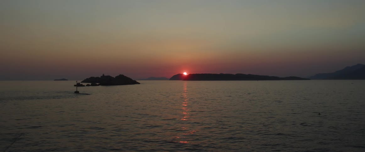 A view of the sun rising over the ocean