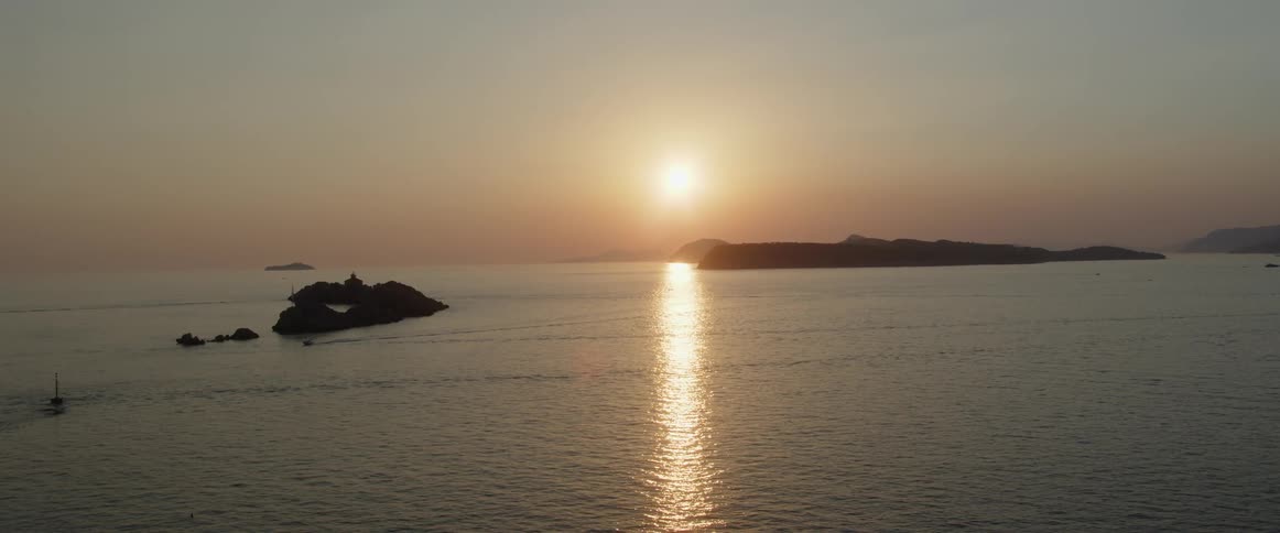 The sun is rising over the ocean