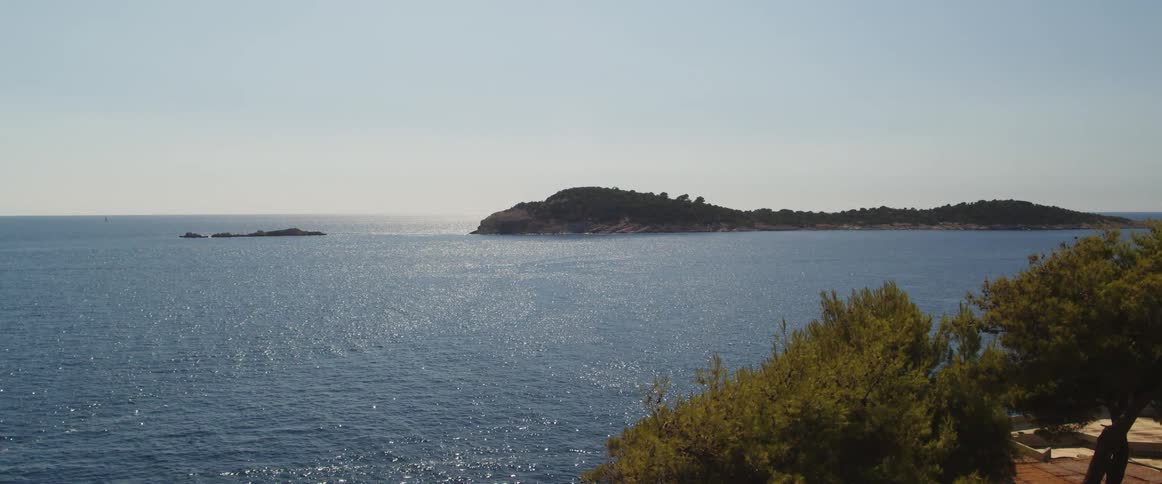 Small waves ripple around a peninsula in the sea