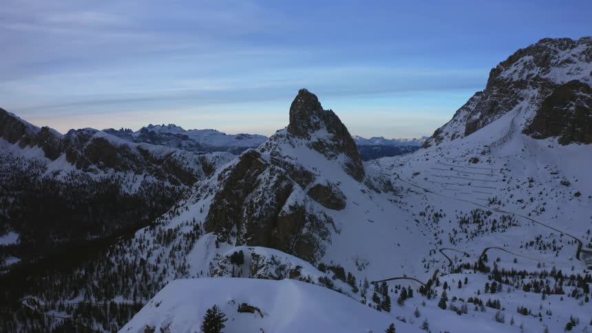 Snow covered mountains under a cloudy sky