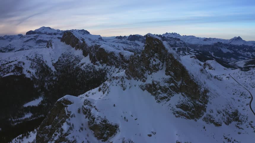 Snow covered mountains under a cloudy sky