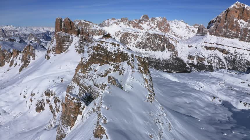 Snow covered mountains with peaks high in the blue sky