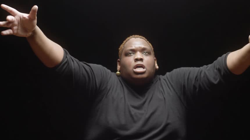 A person dancing in a dark room