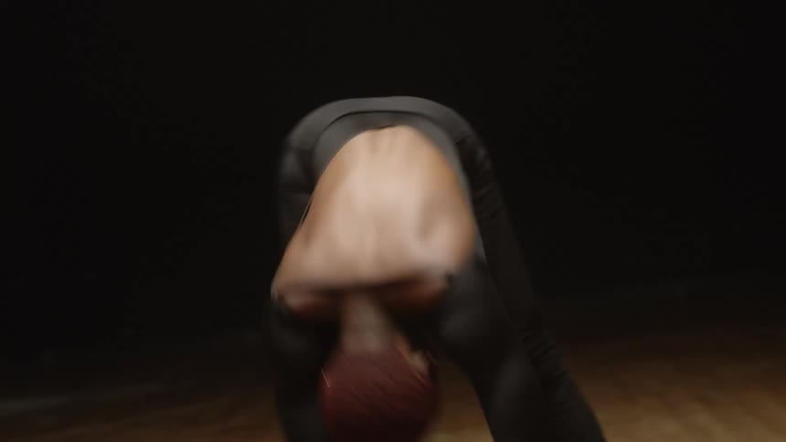 A woman writhes around and moves her arms as she practices a modern dance