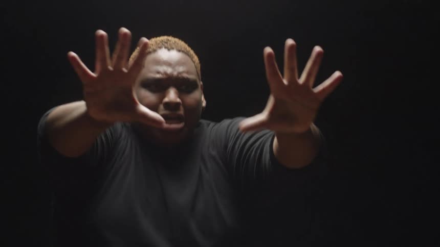 A male performer is doing an expressive dance