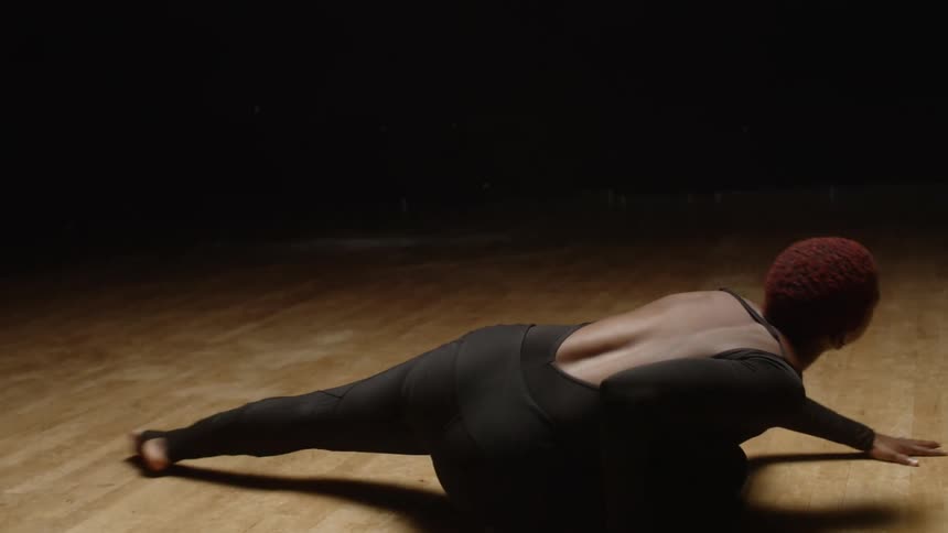 A female performer does an interprative dance on a stage