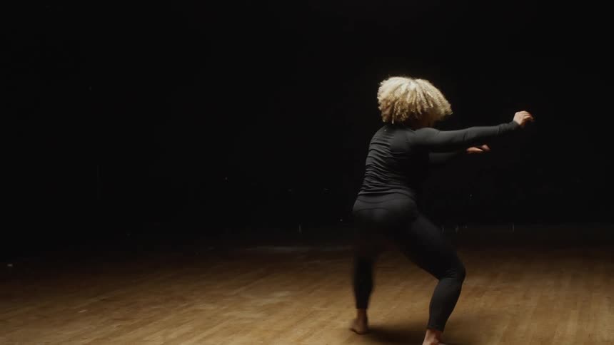 A woman is spinning around dancing