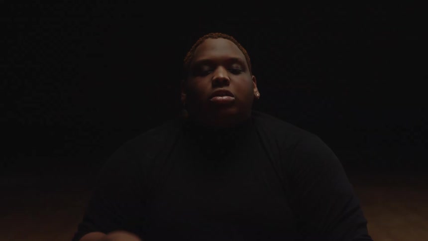 A performer is sitting down and moving his arm around