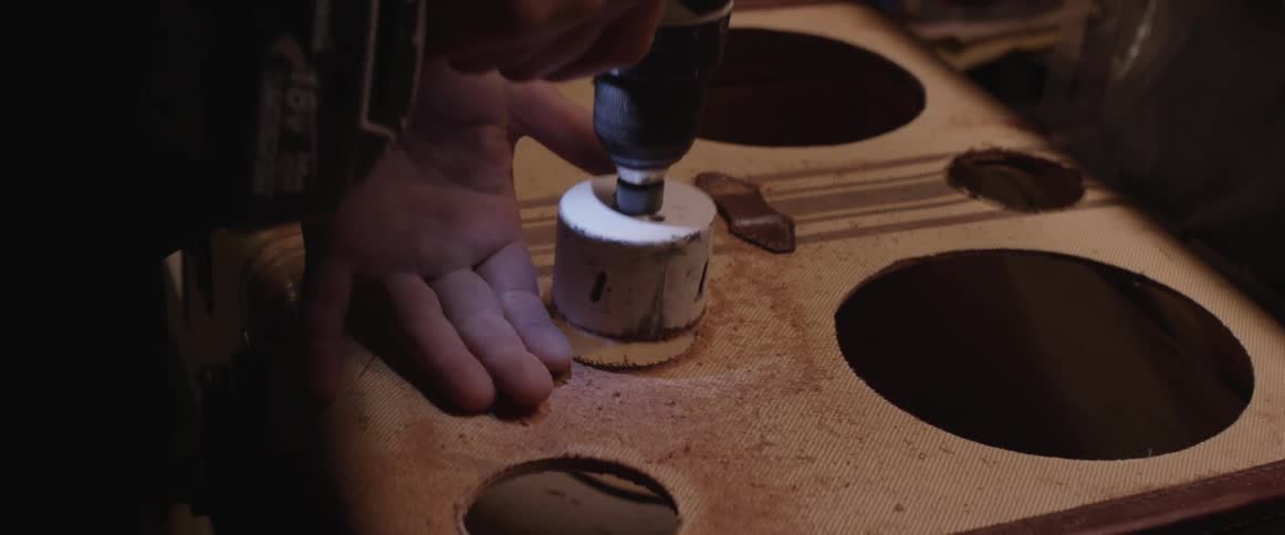 A man drills holes in a case