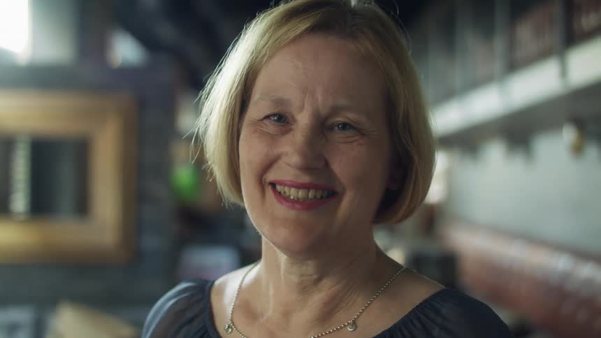 A woman gives a big smile