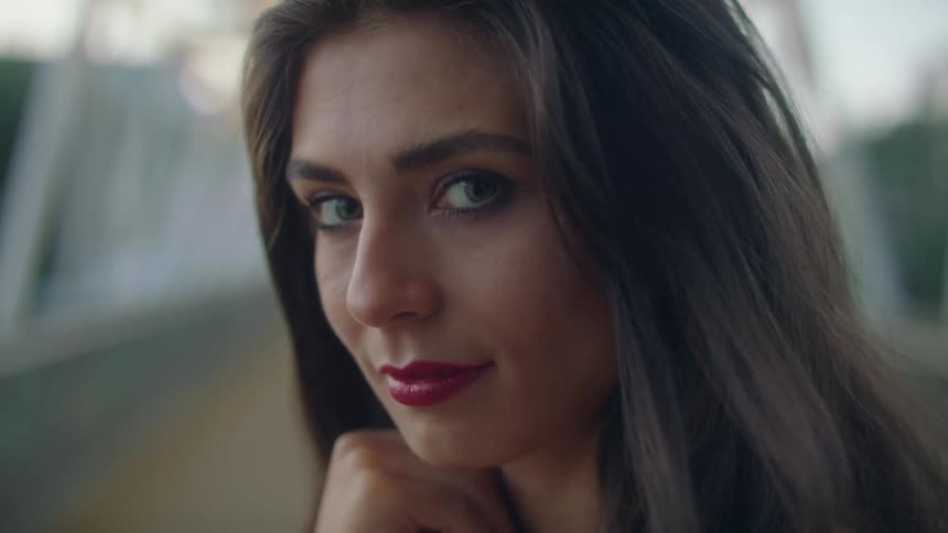 A woman standing and looking into a camera