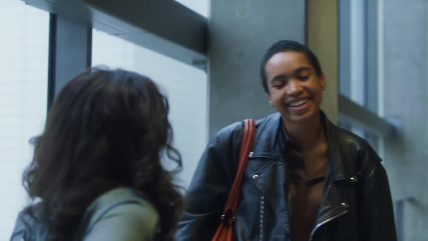 A woman greets and hugs some of her friends