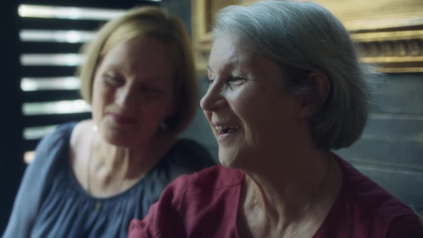 Two women smile and talk