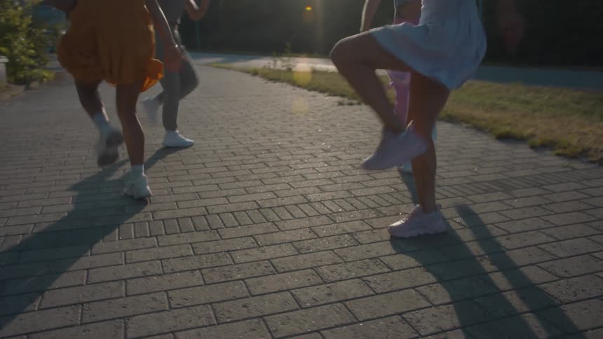 Four women are dancing outside