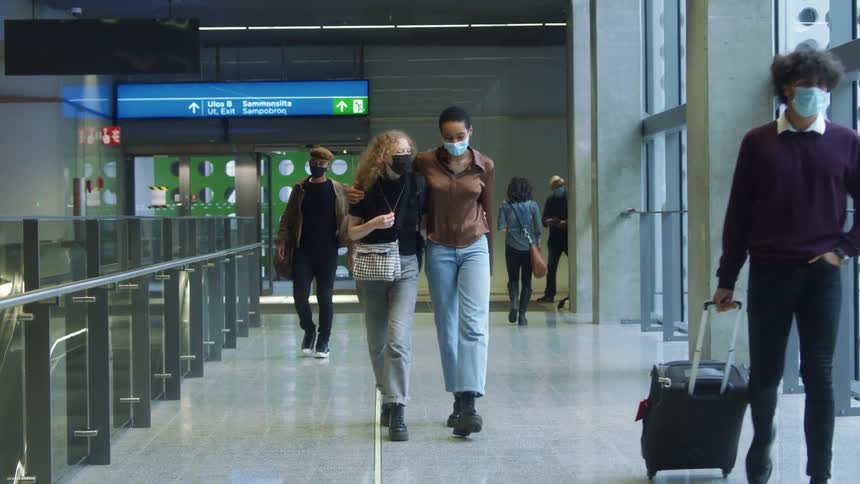Friends walk together in the airport terminal
