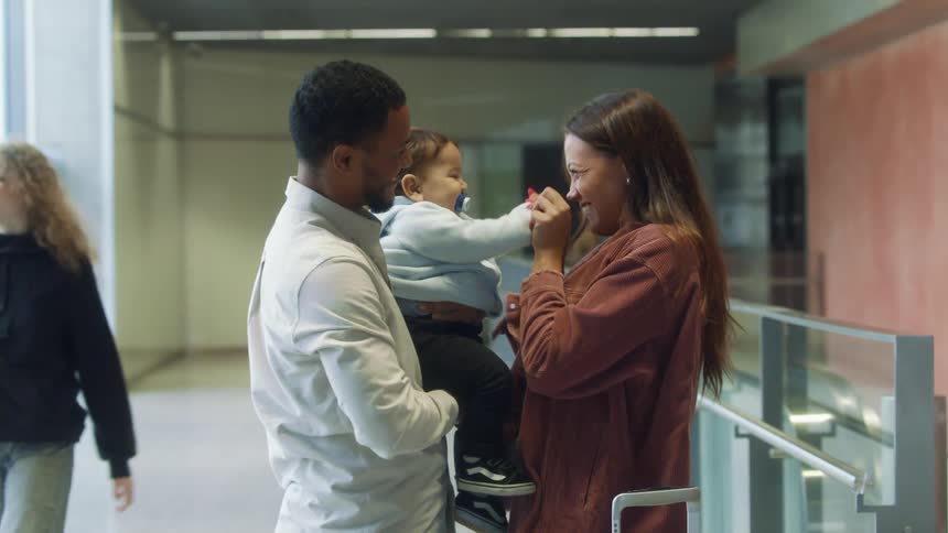 A family smile and talk as they great each other