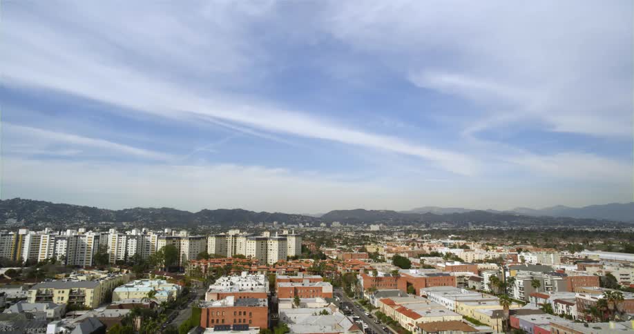 Time lapse of the skyline of a small city near the mountains at daytime