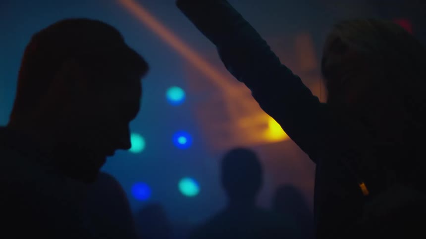 Two people in a crowd dancing in a club