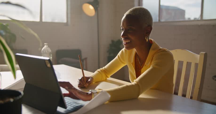 A woman sitting in a room using a laptop