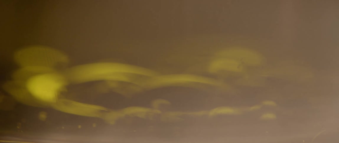 An out of focus view of an object with yellow light shining on it