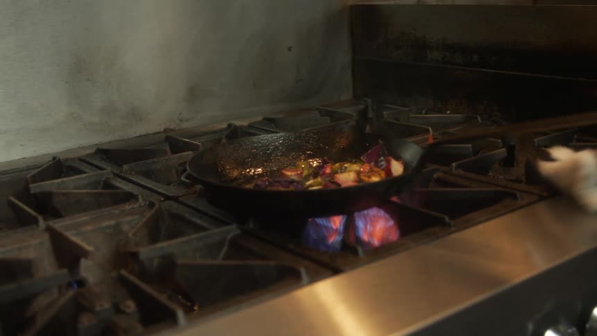 Food cooking in a pan on a stove