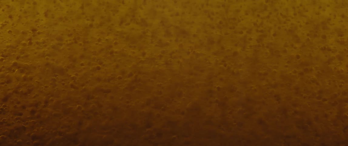 Bubbles fade in orange liquid