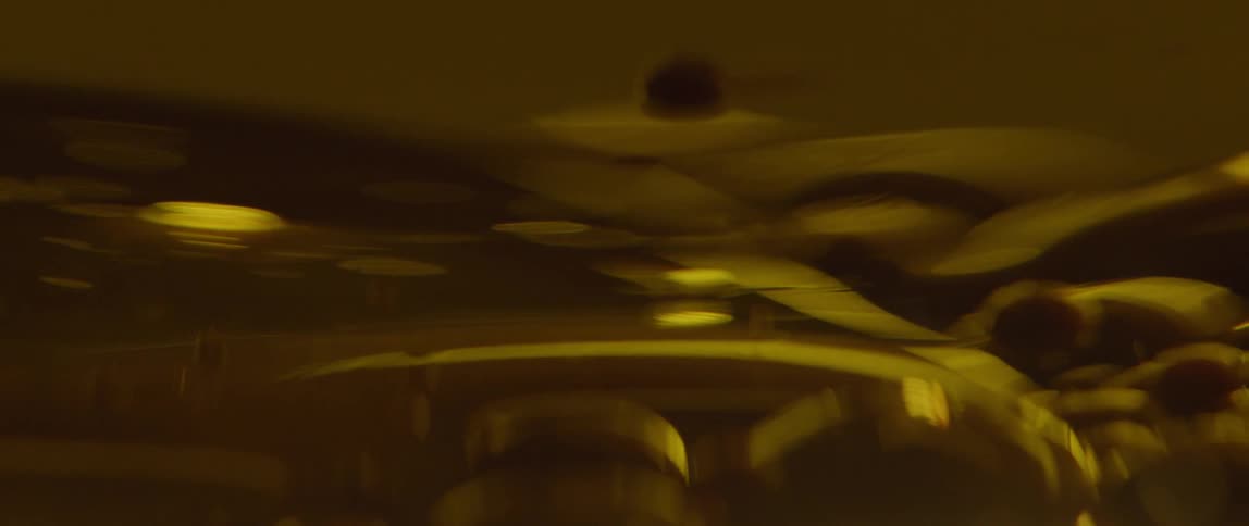 Bubbles fall in a thick yellow liquid