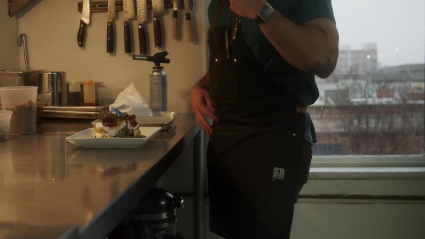 A man cooking food in a kitchen