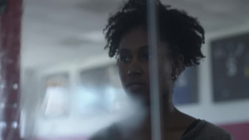 Young woman looking at herself on a dirty mirror inside a gym