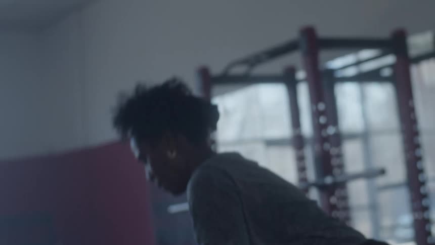 A woman is using an exercise ball in a gym