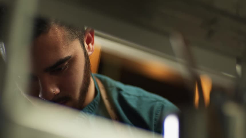A male employee is busy working in a warehouse during the day
