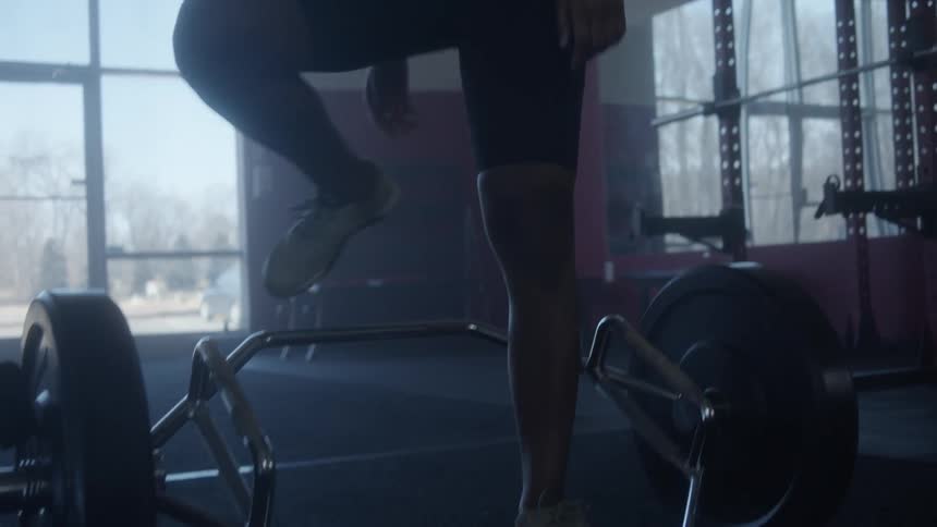 A woman lifts up a heavy weight and drops it