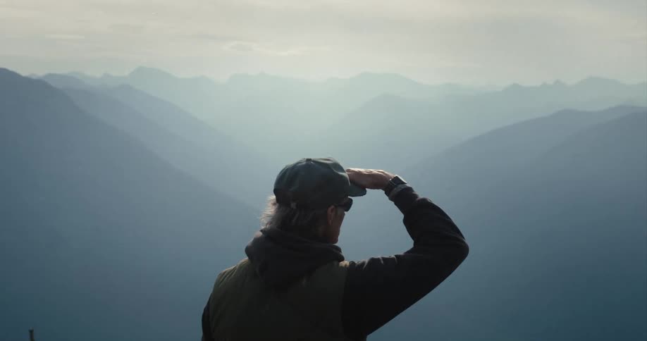 A male hiker stopping to enjoy the view in mountains
