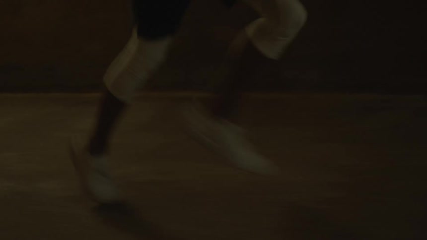 A person is running outside at night