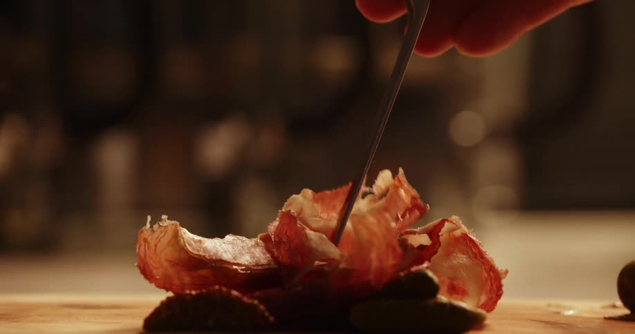 A person picking up food from a table with chopsticks