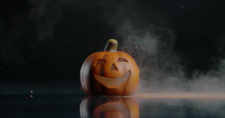 A ceramic pumpkin is exploded in a dark studio environment