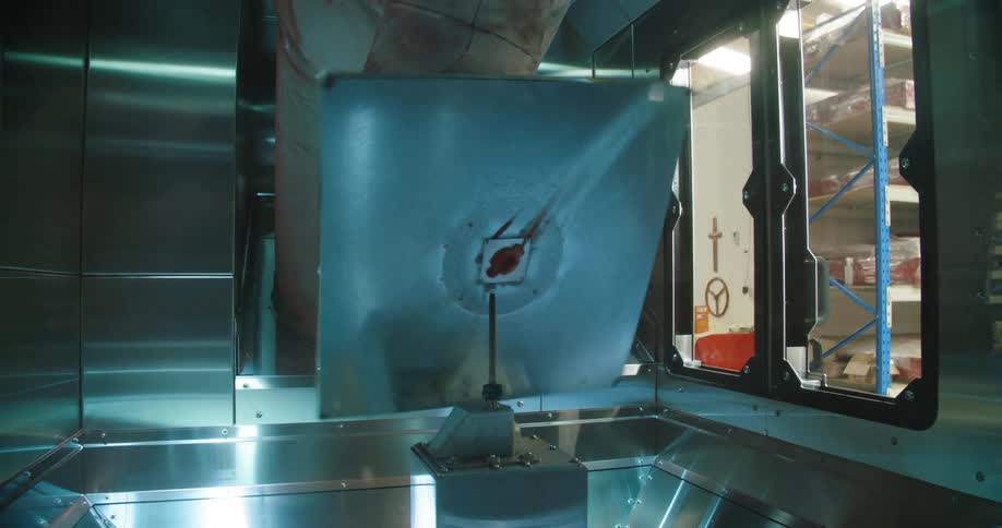 A machine is spinning a square plate in a container