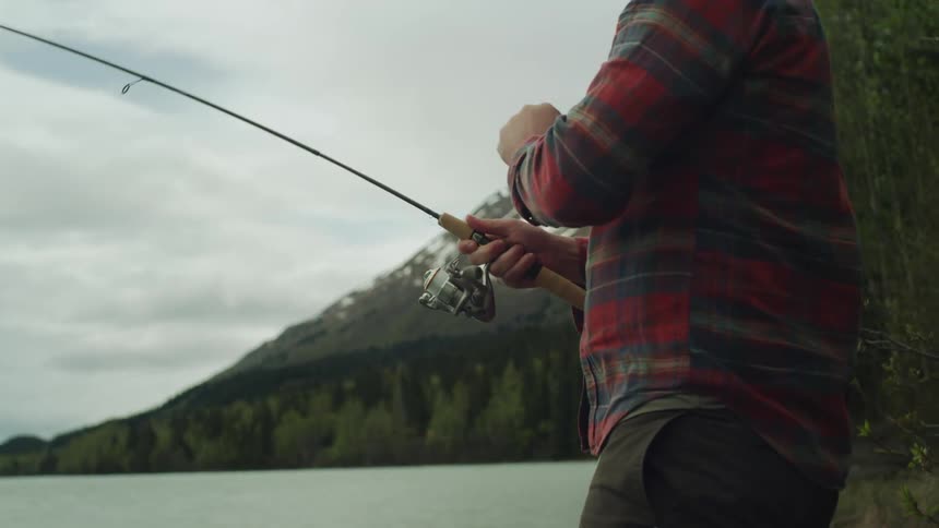 A man is pulling the string as he tries to fish using a fishing rod