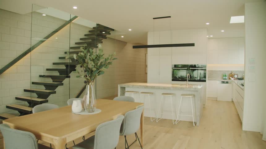 A living room dining room and spacious kitchen sit adjacent to each other in a home with an open floor plan