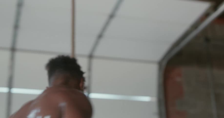 Man sweats while running on treadmill before stopping and walking away