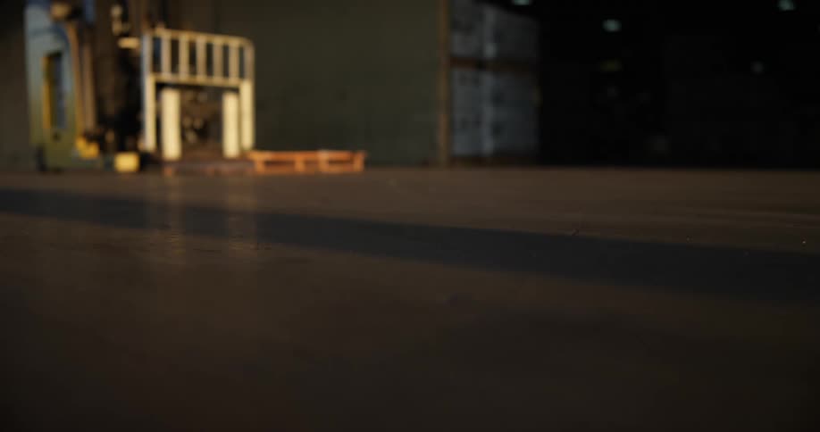 A shadow on the floor shows the approach of a man walking