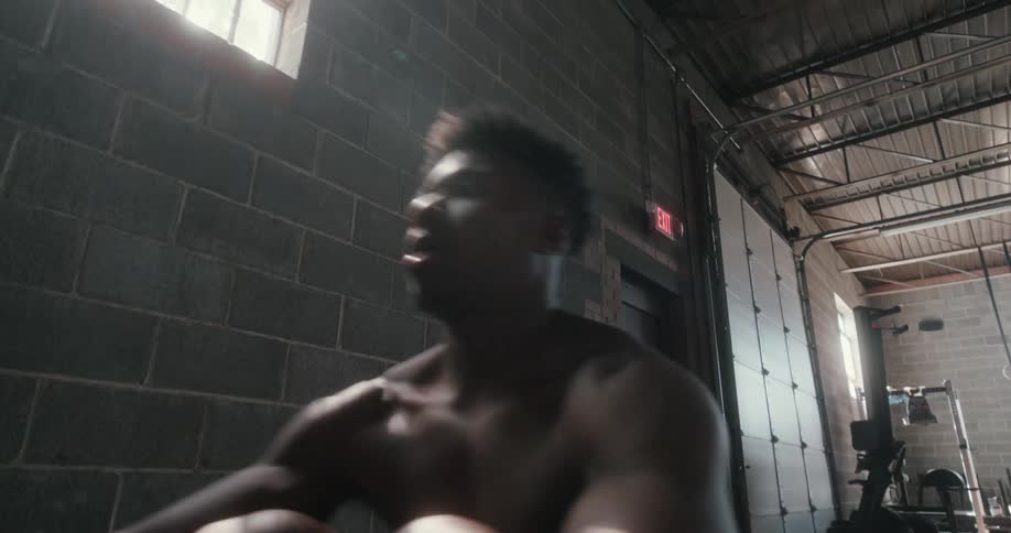 A man is working out on equipment in the gym
