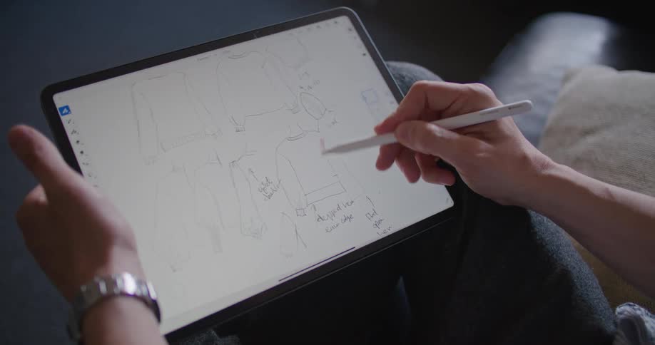 A person drawing on a tablet