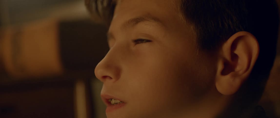 A young boy looks upwards